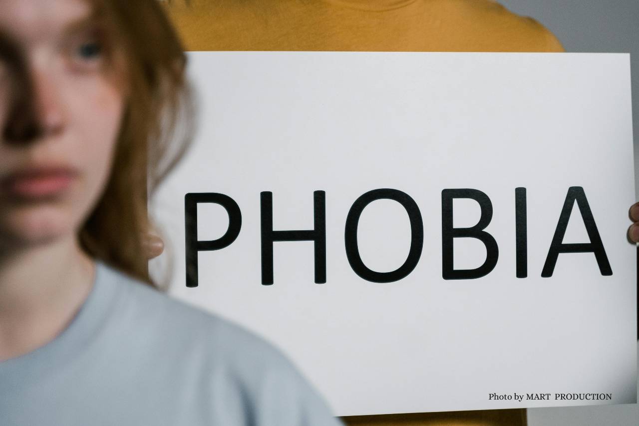 Blurred girl near whiteboard with 'phobia' written