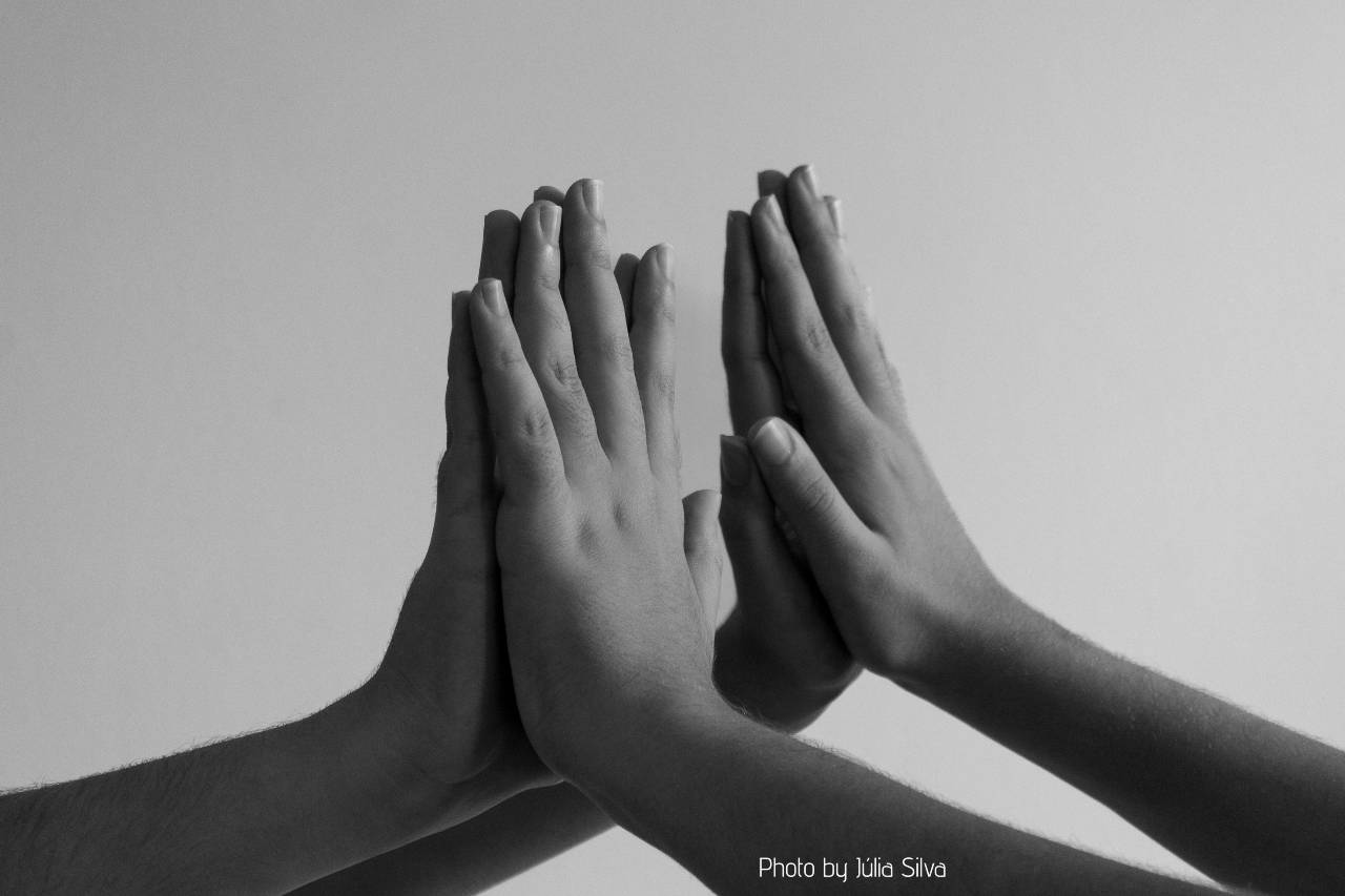 Pair of hands touching palm to palm